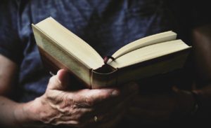 Closeup hand holding an open book