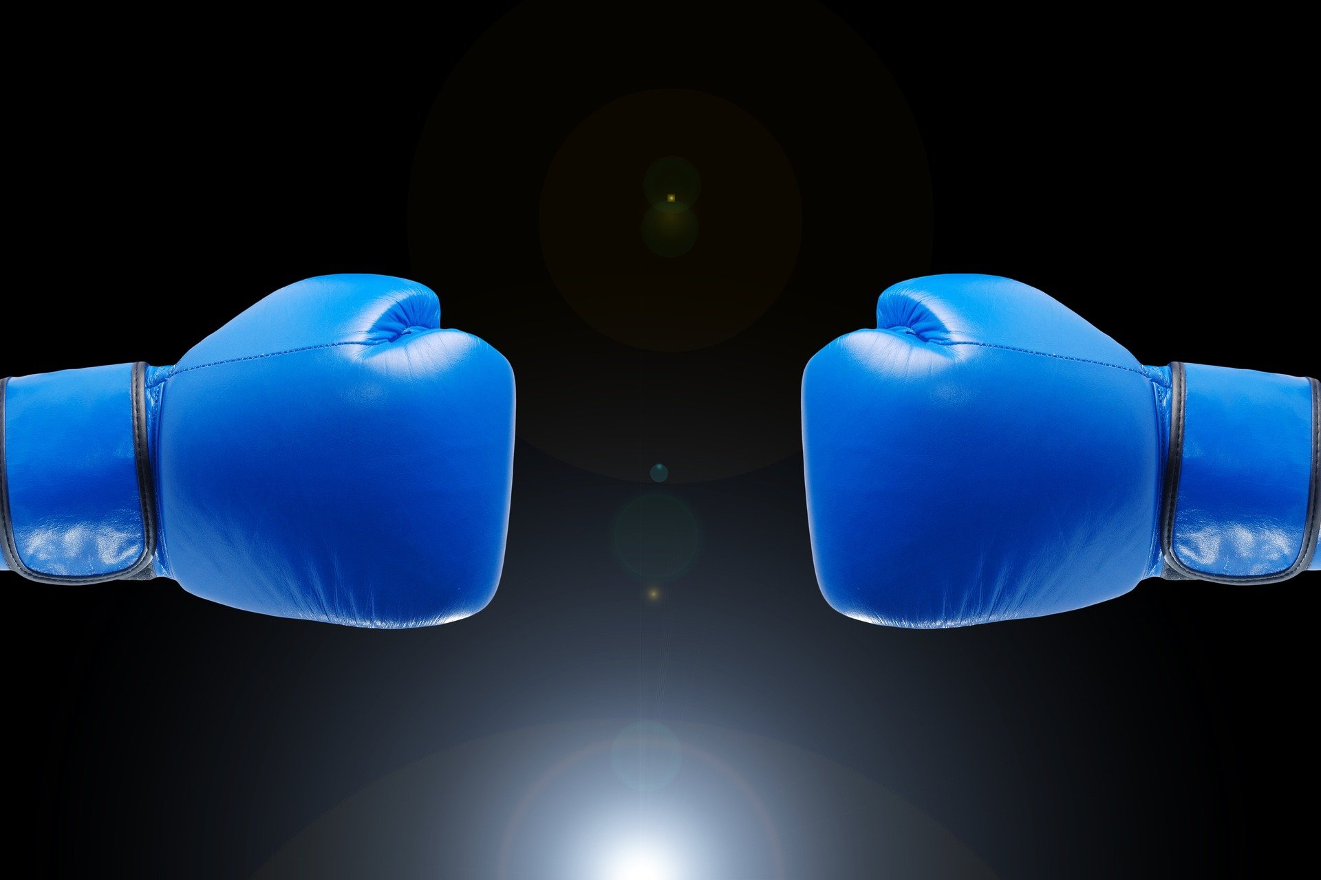 Bright blue boxing gloves representing wills versus trusts