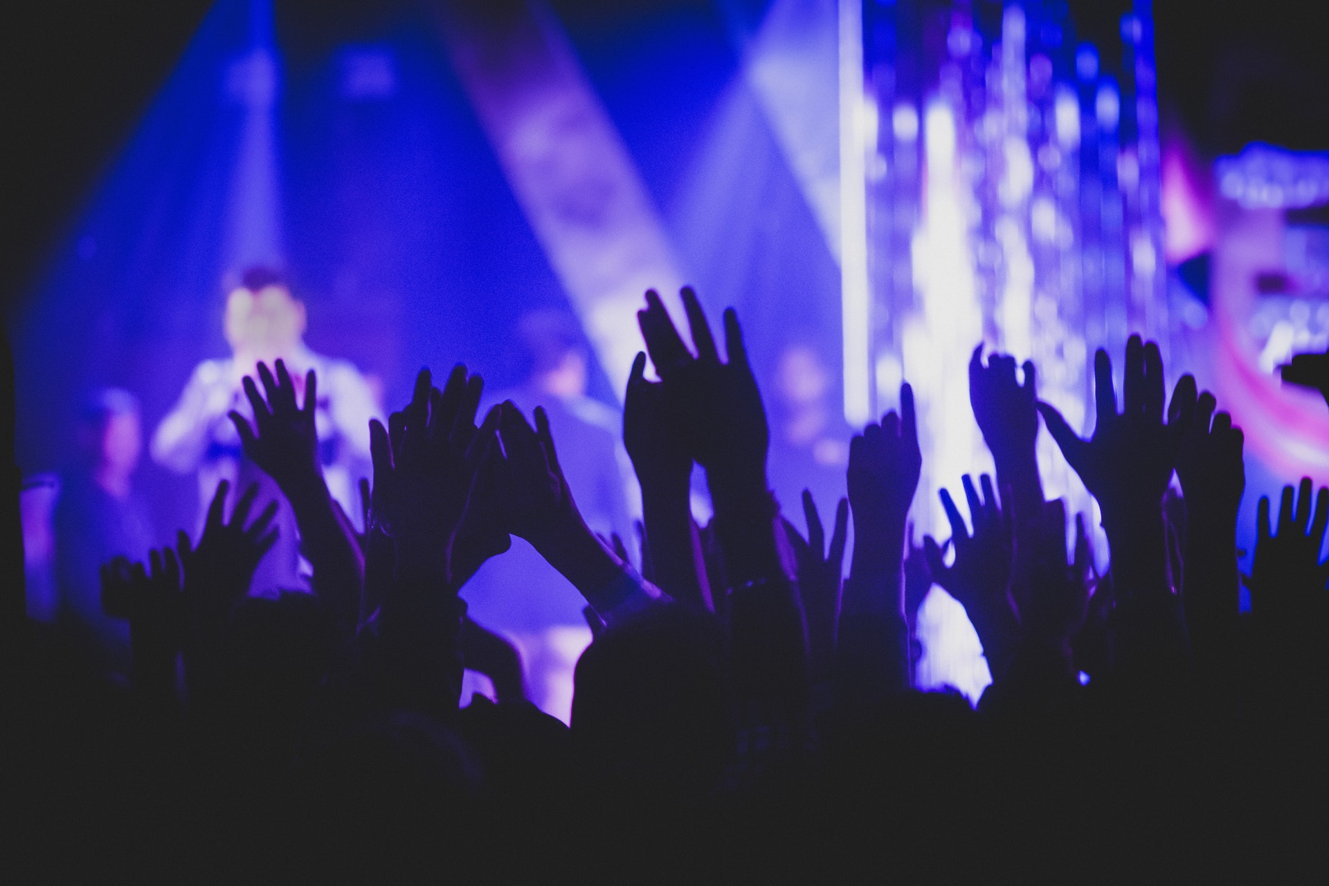 Silhouette raised hands at live concert